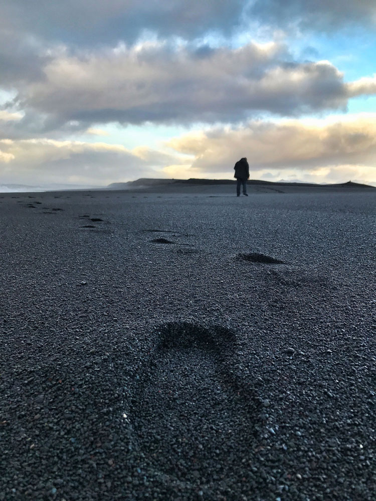 Grief Recovery - Person walking on the beach with footprints in the sand