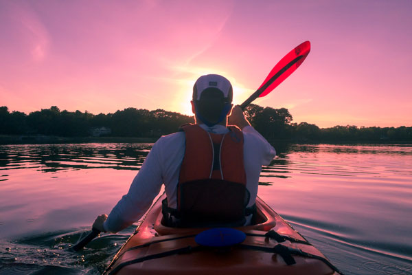 Life Coaching - Man in kayak in front of sunset